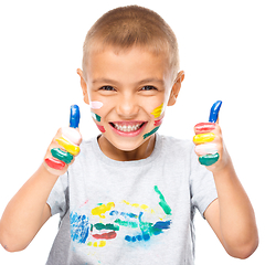 Image showing Portrait of a cute boy playing with paints