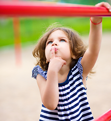 Image showing Cute little girl is playing in playground