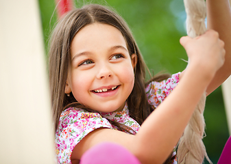 Image showing Cute little girl is playing in playground