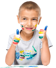 Image showing Portrait of a cute boy playing with paints