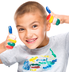 Image showing Portrait of a cute boy playing with paints