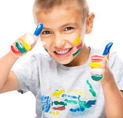 Image showing Portrait of a cute boy playing with paints