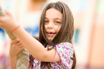 Image showing Cute little girl is playing in playground