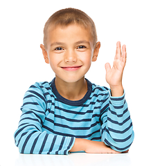 Image showing Little boy is rising his hand up