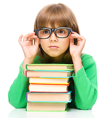 Image showing Little girl is reading a book