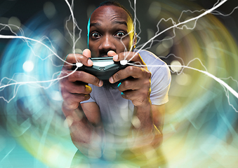 Image showing Enthusiastic gamer. Joyful young man holding a video game controller