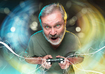 Image showing Enthusiastic gamer. Joyful man holding a video game controller