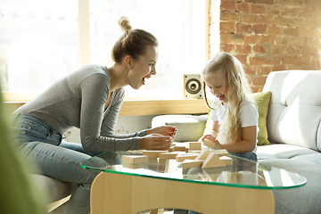 Image showing Teacher and little girl, or mom and daughter. Homeschooling concept