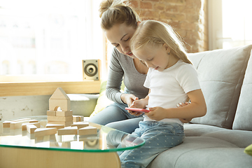 Image showing Teacher and little girl, or mom and daughter. Homeschooling concept