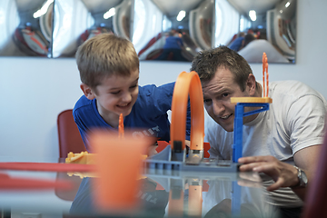 Image showing Father and children playing car toy game