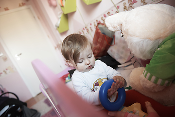 Image showing cute little one year old baby and making first steps