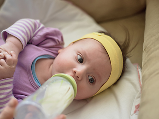 Image showing baby eating milk from bottle