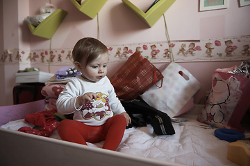 Image showing cute little one year old baby and making first steps