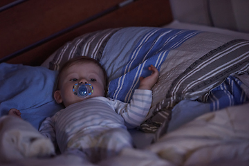 Image showing cute little baby playing and making first steps