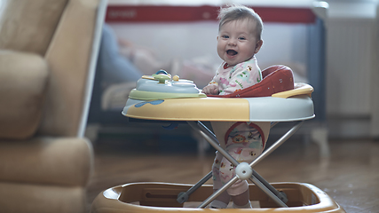 Image showing baby learning to walk in walker