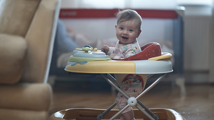 Image showing baby learning to walk in walker