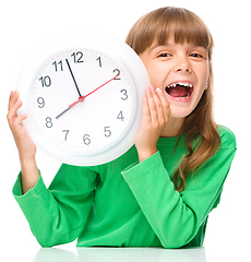 Image showing Little girl is holding big clock