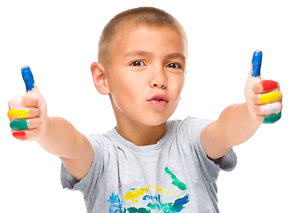 Image showing Portrait of a cute boy playing with paints