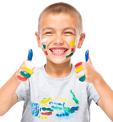 Image showing Portrait of a cute boy playing with paints