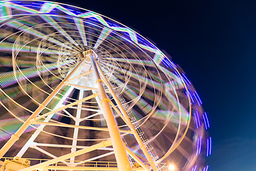 Image showing Ferris wheel moving at night