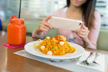 Image showing Woman taking photo on the fried noodles