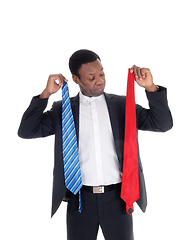 Image showing Man can not decide what necktie to wear