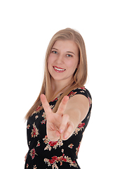 Image showing Woman making victory sign and smiling