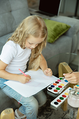 Image showing Teacher and little girl, or mom and daughter. Homeschooling concept