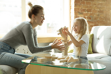 Image showing Teacher and little girl, or mom and daughter. Homeschooling concept