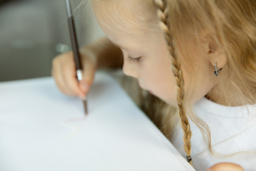 Image showing Little girl studying to write or draw. Homeschooling concept