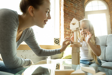 Image showing Teacher and little girl, or mom and daughter. Homeschooling concept