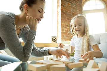 Image showing Teacher and little girl, or mom and daughter. Homeschooling concept