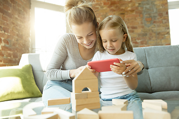 Image showing Teacher and little girl, or mom and daughter. Homeschooling concept