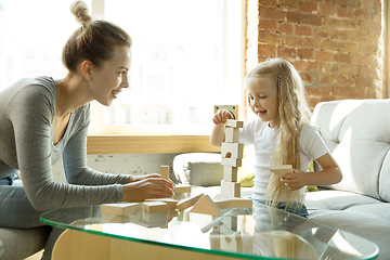 Image showing Teacher and little girl, or mom and daughter. Homeschooling concept