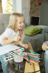 Image showing Teacher and little girl, or mom and daughter. Homeschooling concept