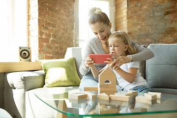 Image showing Teacher and little girl, or mom and daughter. Homeschooling concept