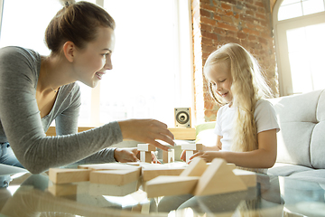 Image showing Teacher and little girl, or mom and daughter. Homeschooling concept