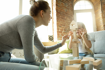 Image showing Teacher and little girl, or mom and daughter. Homeschooling concept