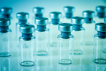 Image showing Vaccine glass bottles on blue background