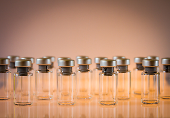 Image showing Vaccine glass bottles on orange background