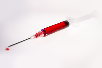 Image showing Syringe with blood on white background