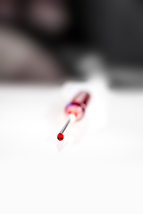Image showing Syringe needle with blood macro view
