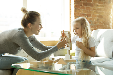 Image showing Teacher and little girl, or mom and daughter. Homeschooling concept