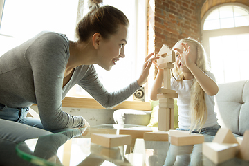 Image showing Teacher and little girl, or mom and daughter. Homeschooling concept