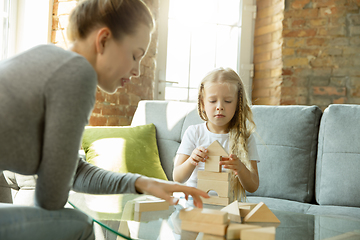 Image showing Teacher and little girl, or mom and daughter. Homeschooling concept