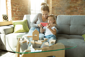 Image showing Teacher and little girl, or mom and daughter. Homeschooling concept