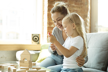 Image showing Teacher and little girl, or mom and daughter. Homeschooling concept