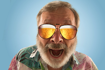 Image showing Oktoberfest senior man with sunglasses full of light beer