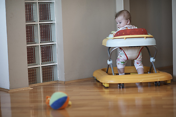 Image showing baby learning to walk in walker