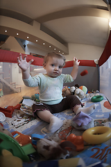 Image showing cute little baby playing in mobile bed